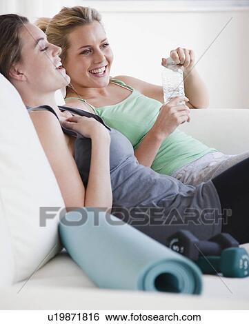 Stock Photograph - Resting after yoga class. Fotosearch