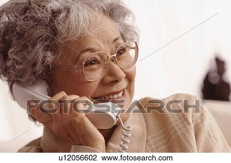 Stock Image - Senior on the phone. Fotosearch
