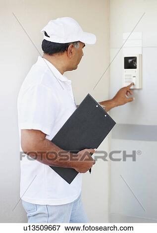 Stock Photo - Setting alarm. Fotosearch