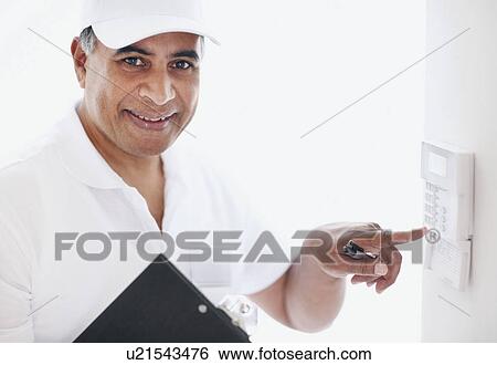 Stock Photograph - Setting alarm. Fotosearch