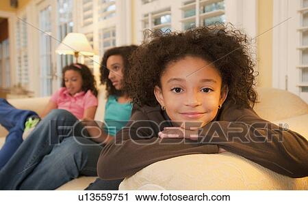 Sisters on couch View Large Photo Image Stock Image - Sisters on couch. Fotosearch