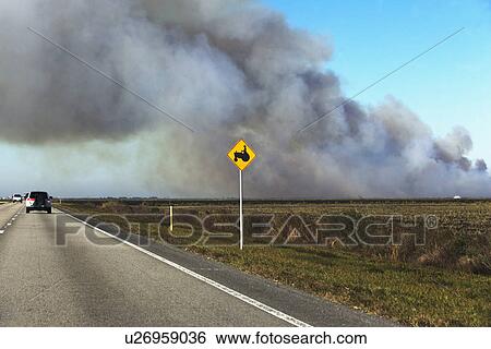 Stock Photograph - Smoke over road. Fotosearch