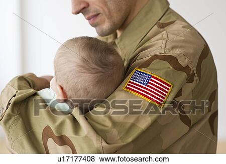 Soldier holding baby View Large Photo Image Stock Photo - Soldier holding baby. Fotosearch