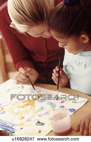 Student painting with teacher View Large Photo Image Stock Photo - Student painting with teacher. Fotosearch