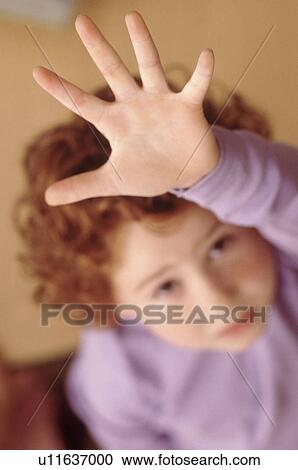 Stock Image - Student raising hand. Fotosearch