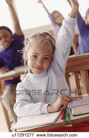 Stock Photo - Students in classroom raising hands. Fotosearch