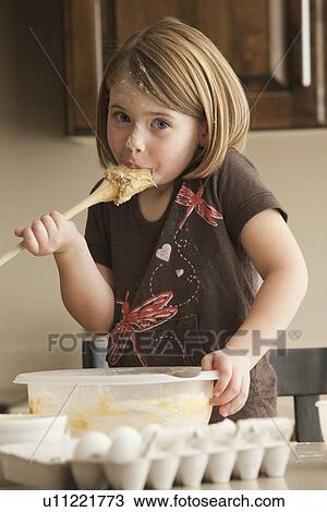 Stock Image - Tasting the batter. Fotosearch