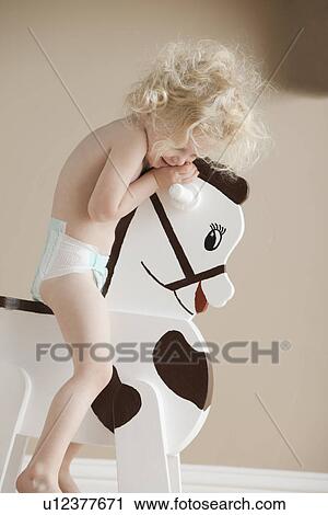 Toddler on rocking horse View Large Photo Image Stock Image - Toddler on rocking horse. Fotosearch