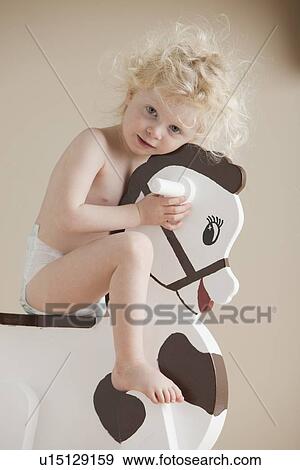 Toddler on rocking horse View Large Photo Image Stock Photo - Toddler on rocking horse. Fotosearch