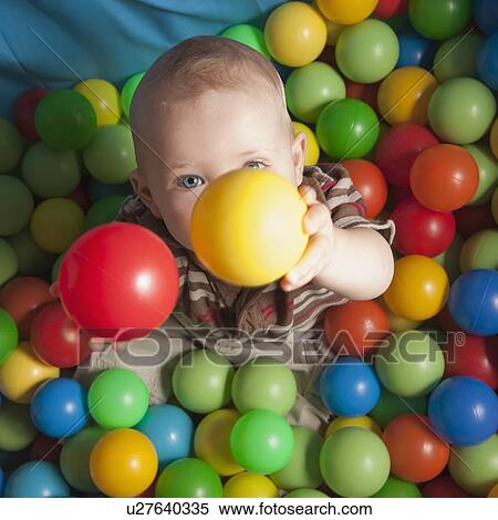 Stock Photography - Toddler playing with balls. Fotosearch