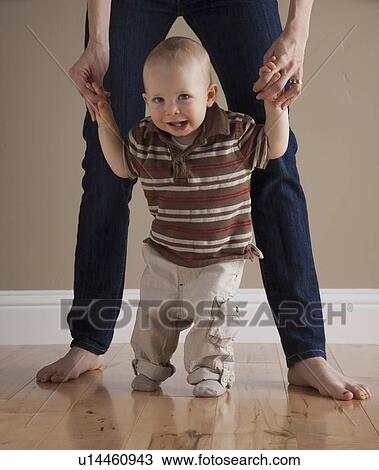 Stock Image - Toddler's first steps. Fotosearch