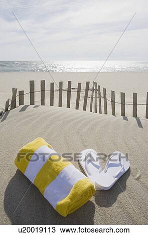 Towel and flip flops on the beach View Large Photo Image Stock Image - Towel and flip flops on the beach. Fotosearch
