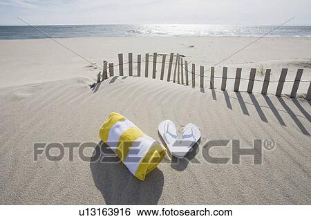 Towel and flip flops on the beach View Large Photo Image Stock Photograph - Towel and flip flops on the beach. Fotosearch