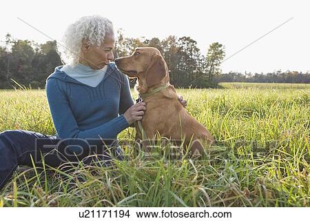 Picture - Woman and her dog. Fotosearch