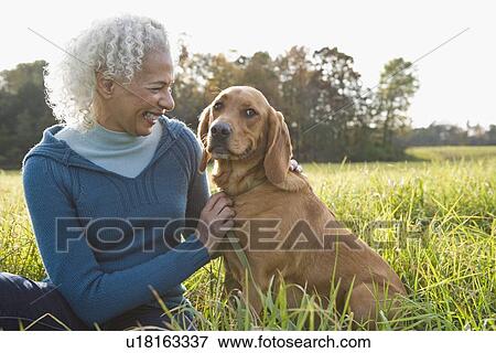 Stock Photo - Woman and her dog. Fotosearch