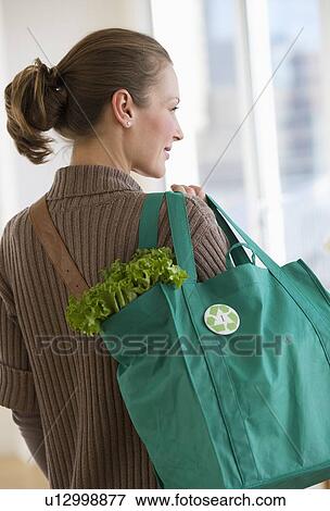 Woman carrying bag of groceries View Large Photo Image Stock Photo - Woman carrying bag of groceries. Fotosearch