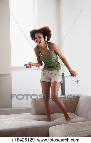 Woman dancing on couch View Large Photo Image Stock Photo - Woman dancing on couch. Fotosearch