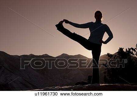 Stock Image - Woman doing yoga outdoors. Fotosearch