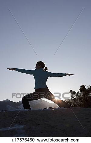 Stock Image - Woman doing yoga outdoors. Fotosearch