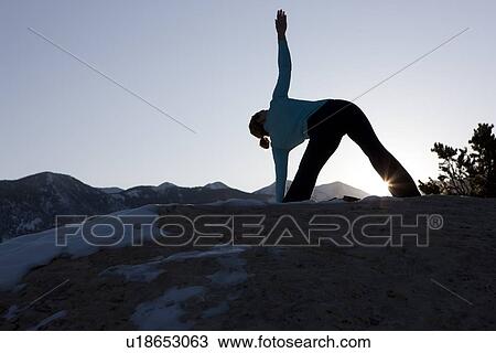 Stock Image - Woman doing yoga outdoors. Fotosearch