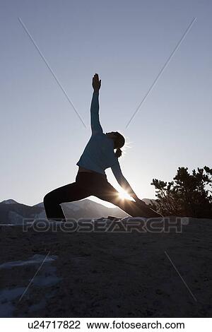 Stock Image - Woman doing yoga outdoors. Fotosearch