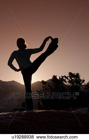 Stock Photo - Woman doing yoga outdoors. Fotosearch