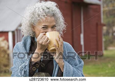 Woman drinking from mug View Large Photo Image Stock Image - Woman drinking from mug. Fotosearch