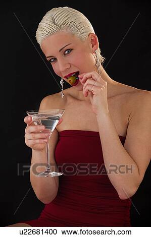 Stock Image - Woman drinking martini. Fotosearch