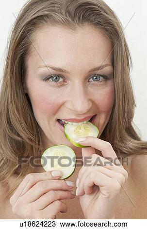 Woman eating cucumber View Large Photo Image Stock Image - Woman eating cucumber. Fotosearch