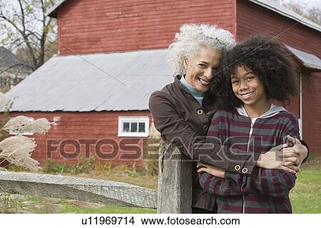 Woman embracing child View Large Photo Image Picture - Woman embracing child. Fotosearch