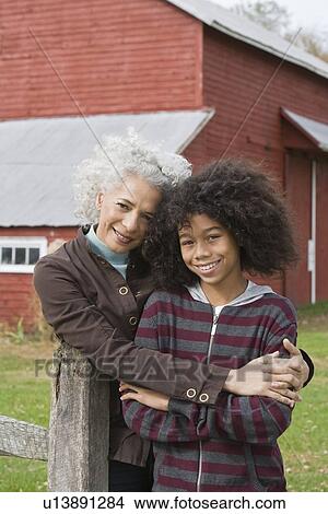 Picture - Woman embracing child. Fotosearch