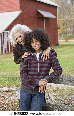 Woman embracing child View Large Photo Image Stock Image - Woman embracing child. Fotosearch