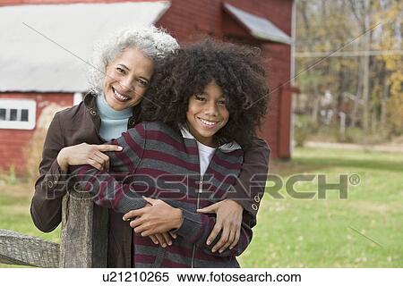 Woman embracing child View Large Photo Image Stock Photography - Woman embracing child. Fotosearch