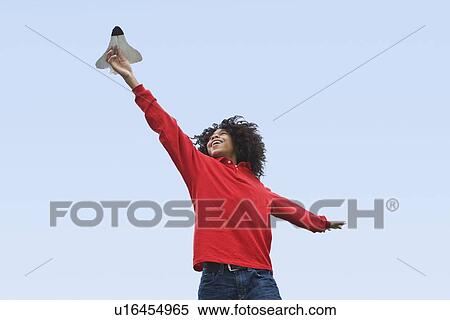 Woman flying toy plane View Large Photo Image Stock Photography - Woman flying toy plane. Fotosearch