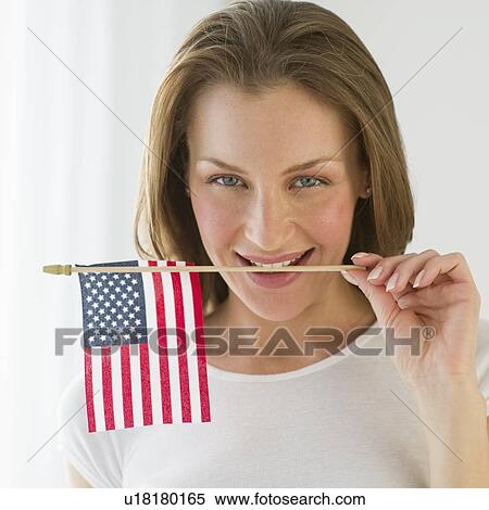 Stock Photography - Woman holding American flag. Fotosearch