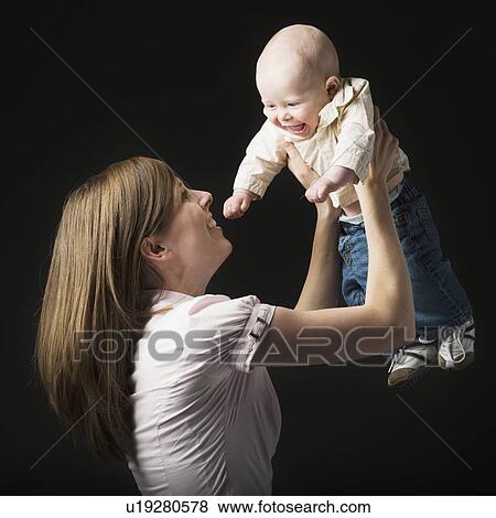 Stock Photo - Woman holding baby. Fotosearch