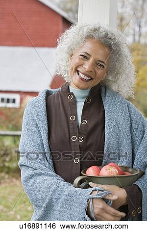Woman holding bowl of apples View Large Photo Image Stock Photograph - Woman holding bowl of apples. Fotosearch