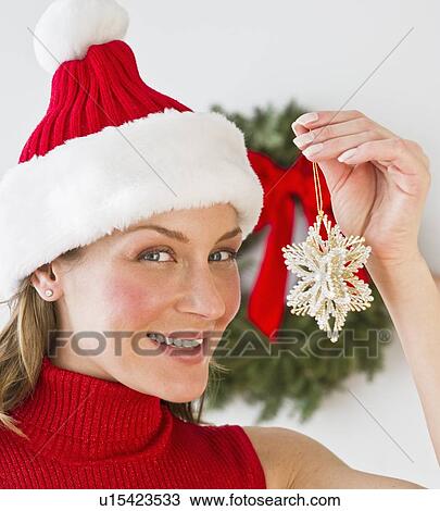 Woman holding Christmas decoration View Large Photo Image Stock Image - Woman holding Christmas decoration. Fotosearch
