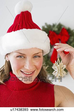 Woman holding Christmas decoration View Large Photo Image Stock Image - Woman holding Christmas decoration. Fotosearch