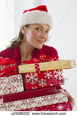 Woman holding Christmas presents View Large Photo Image Stock Image - Woman holding Christmas presents. Fotosearch