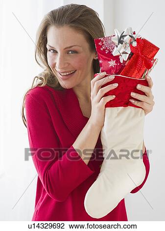 Woman holding Christmas stocking View Large Photo Image Stock Image - Woman holding Christmas stocking. Fotosearch