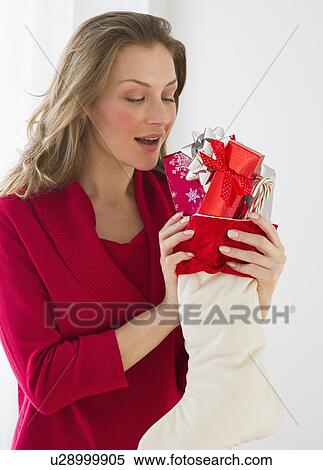 Woman holding Christmas stocking View Large Photo Image Stock Photography - Woman holding Christmas stocking. Fotosearch