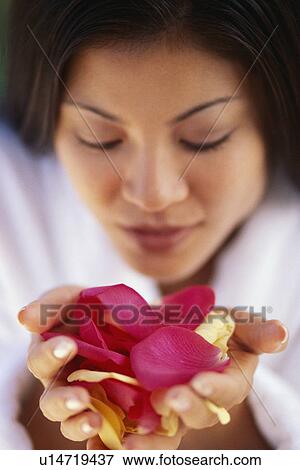 Stock Photo - Woman holding flower petals. Fotosearch