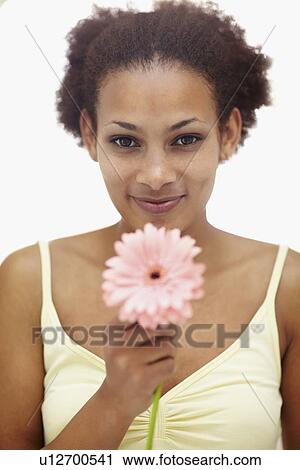 Stock Image - Woman holding flower. Fotosearch