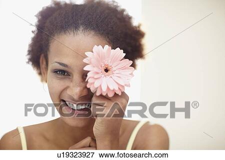 Woman holding flower View Large Photo Image Stock Photo - Woman holding flower. Fotosearch