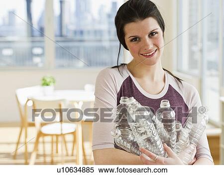 Woman holding plastic water bottles View Large Photo Image Stock Photography - Woman holding plastic water bottles. Fotosearch