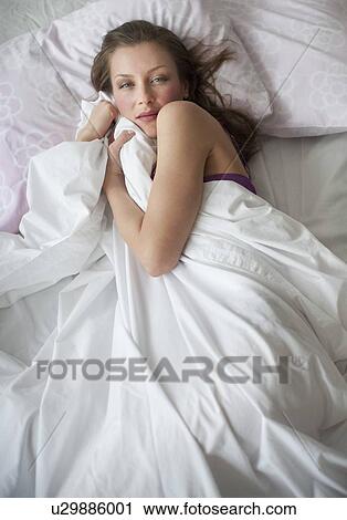 Stock Image - Woman in bed. Fotosearch
