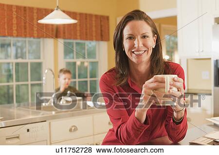 Woman in kitchen View Large Photo Image Stock Photo - Woman in kitchen. Fotosearch