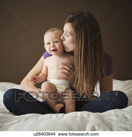 Woman kissing baby View Large Photo Image Picture - Woman kissing baby. Fotosearch