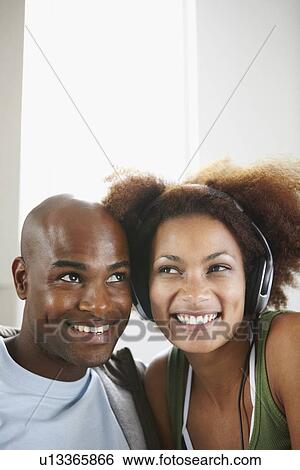 Woman listening to music on headphones View Large Photo Image Stock Photograph - Woman listening to music on headphones. Fotosearch
